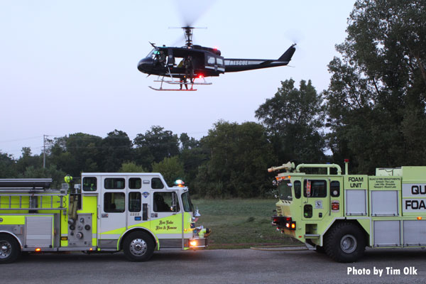 背景是一架直升机。当地消防机构与警方配合,搜寻昨天在伊利诺斯州福克斯湖射杀一名警察的嫌疑人。